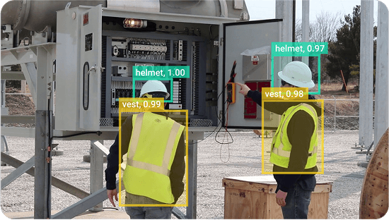 construction workers in hardhats and safety vests marked by computer vision boundary boxes